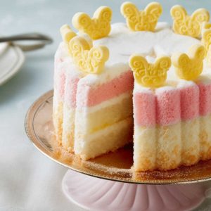 Angel Birthday Cake with decorative icing and biscuits on top