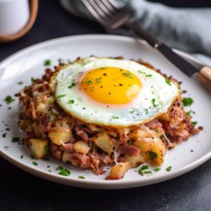 Corned Beef Hash with diced yukon potatoes, corned beef, onion and fried egg