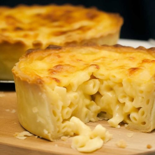Golden-baked macaroni and cheese pies cooling on a rack after coming out of the oven