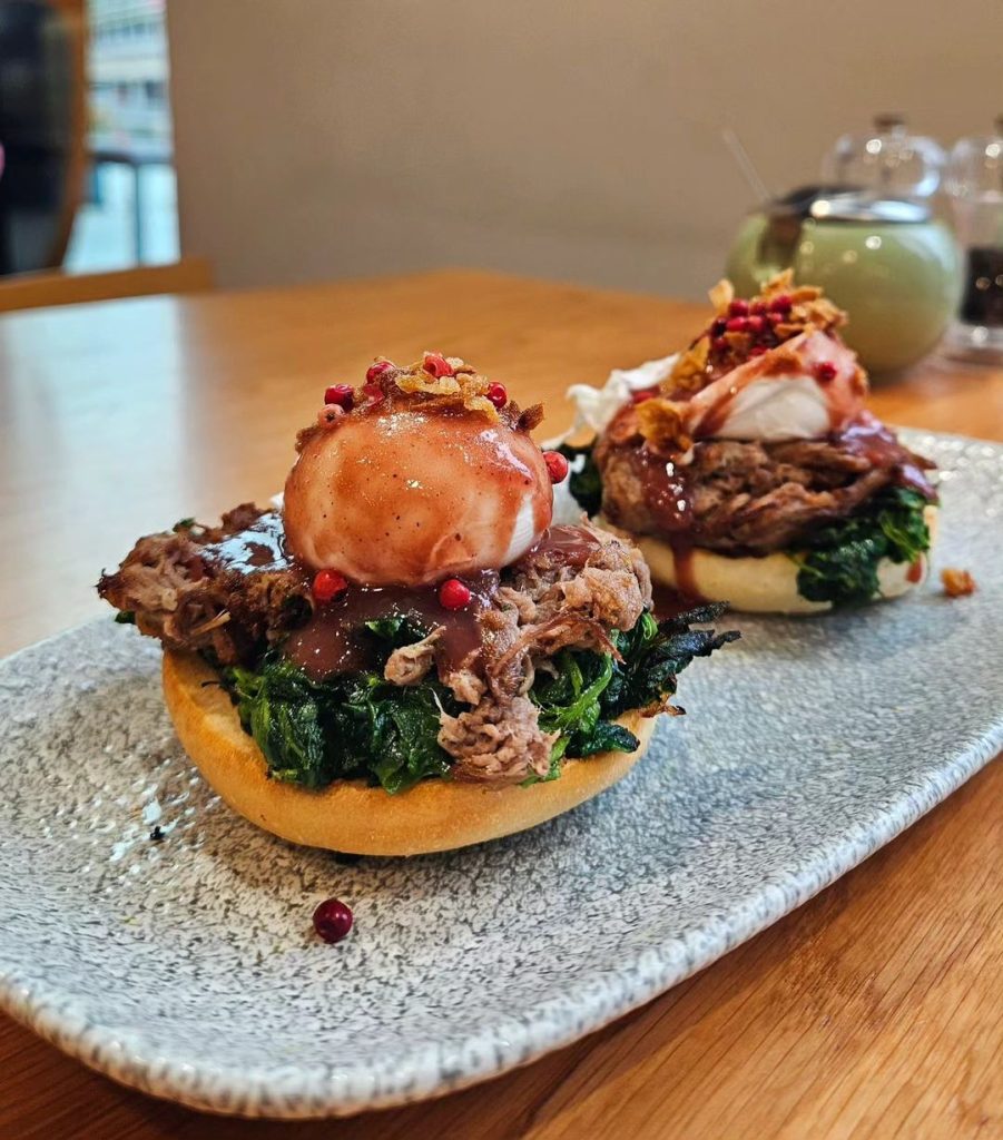 Peppered Beef Brisket Benny - topped with spinach, perfectly poached eggs, red wine sauce and kibbled onions 