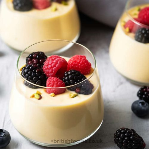 scottish whisky dessert in a glass filled with whisky custard and topped with berries