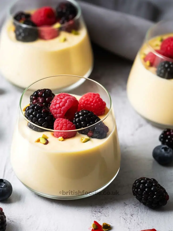 scottish whisky dessert in a glass filled with whisky custard and topped with berries
