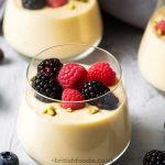 scottish whisky dessert in a glass filled with whisky custard and topped with berries