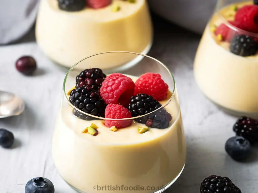 scottish whisky dessert in a glass filled with whisky custard and topped with berries